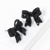 Pave bow stud earrings
: Jet
